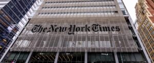 The New York Times building in New York, NY with a focus on the Old English Script branding.