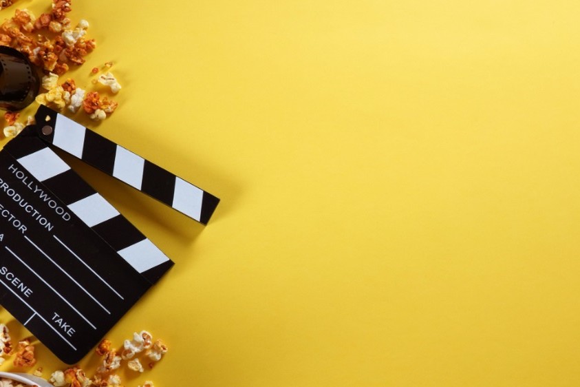 Clapperboard, movie popcorn, and movie film