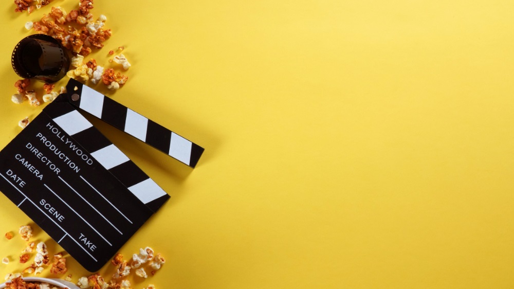 Clapperboard, movie popcorn, and movie film