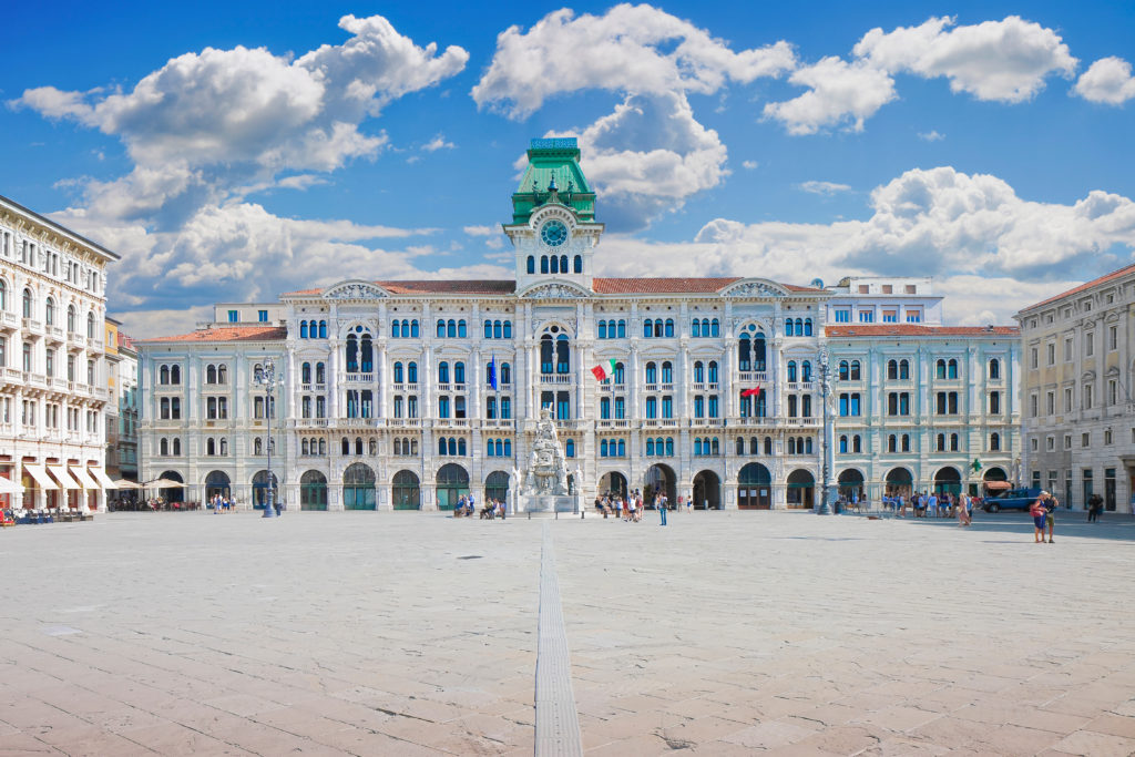 Photo of Trieste, the main Italian port for coffee. Paved mall (wide open space) in front of a large storied building. Intellectual life in the cities centered around the coffeehouses, where people gathered together to discuss Enlightenment ideas.