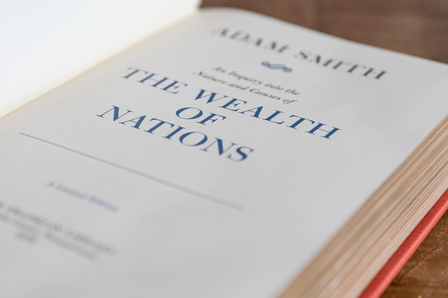 The Wealth of Nations by Adam Smith cover photographed. The cover was a profile of Adam Smith and the title The Wealth of Nations.