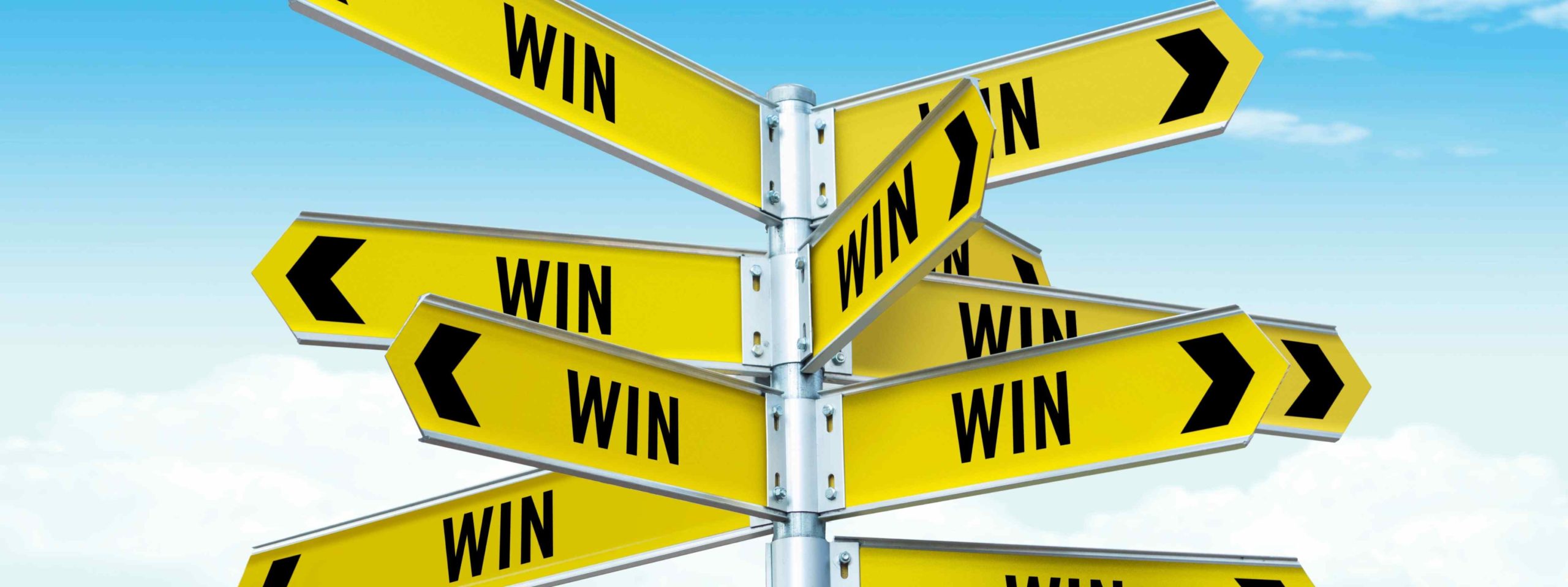 Street sign pointing in many directions that reads Win